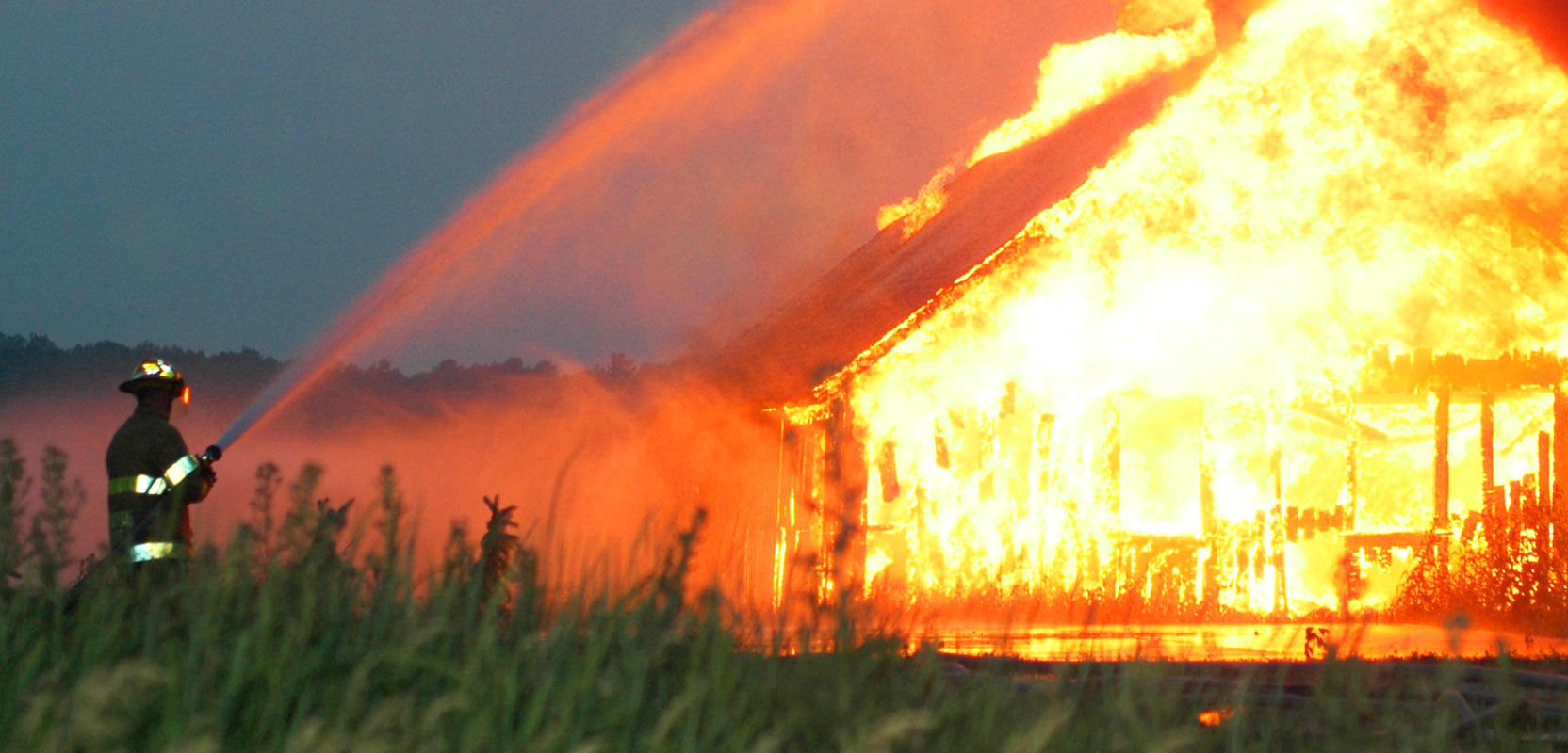 Firefighter putting out house on fire