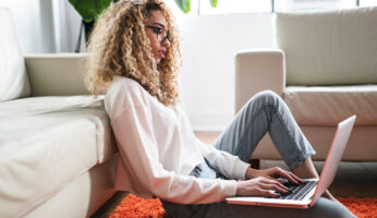 Woman using laptop to buy renters insurance